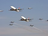 Two SAA cargo aircraft in formation with the Silver Falcons and two Harvards