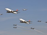 Two SAA cargo aircraft in formation with the Silver Falcons and two Harvards