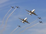 Two SAA cargo aircraft in formation with the Silver Falcons