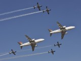Two SAA cargo aircraft in formation with the Silver Falcons